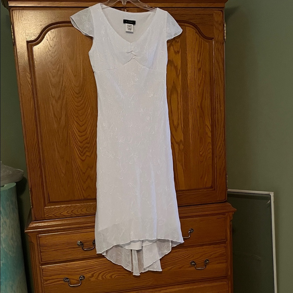 White dress. Was worn as a wedding dress for a beach wedding.